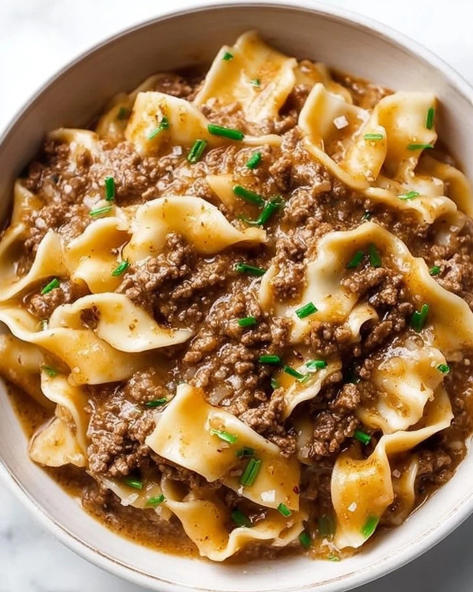Delicious easy beef and noodles recipe served in a bowl with fresh herbs.